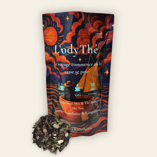 Mélange de thé vert Chun Mee et thé blanc Pai Mu Tan en vrac L'odyThé par La Bibliothéière, saveur framboise et gingembre. Sachet illustré et feuilles de thé de qualité supérieure visibles.